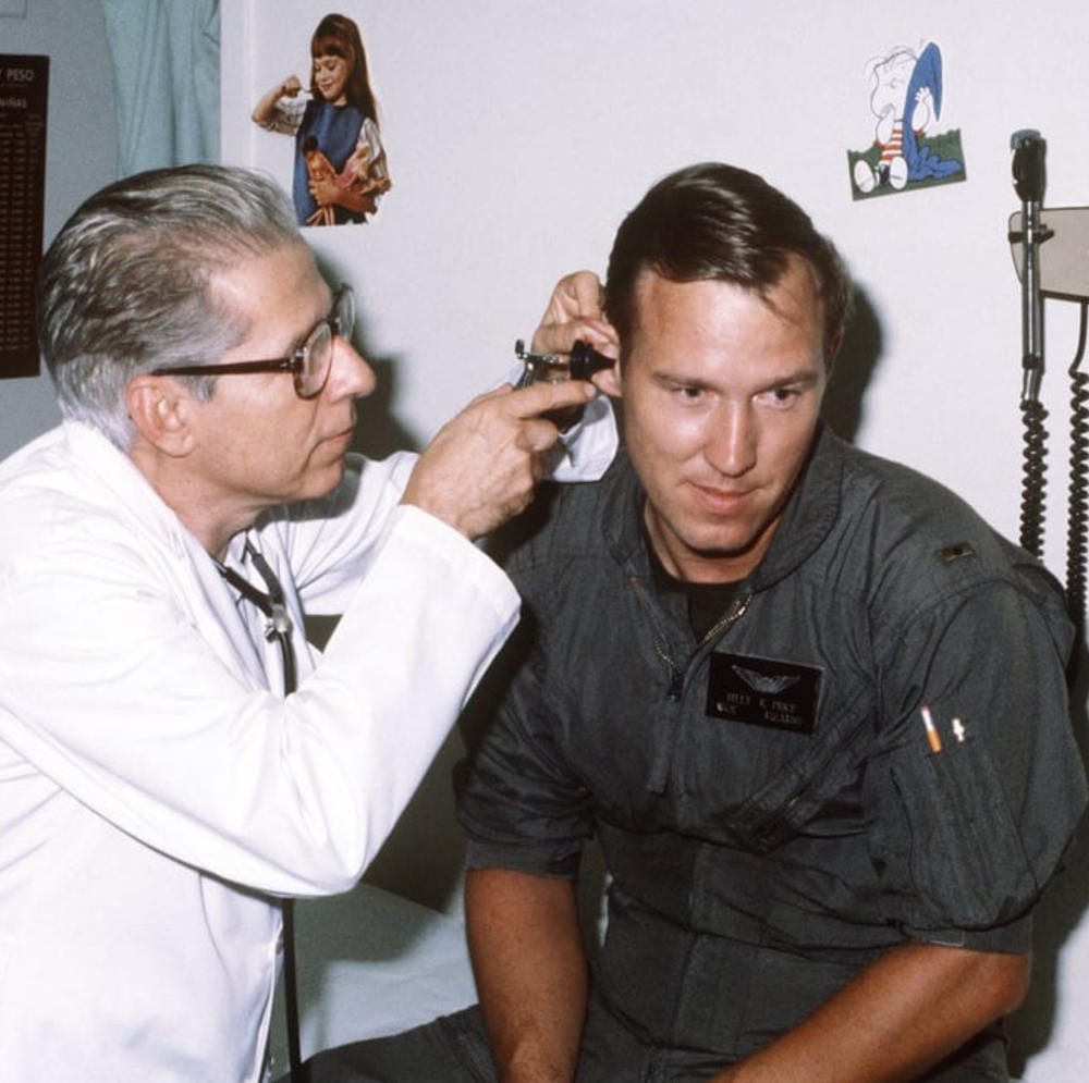 photo of a doctor looking into a patient's ear